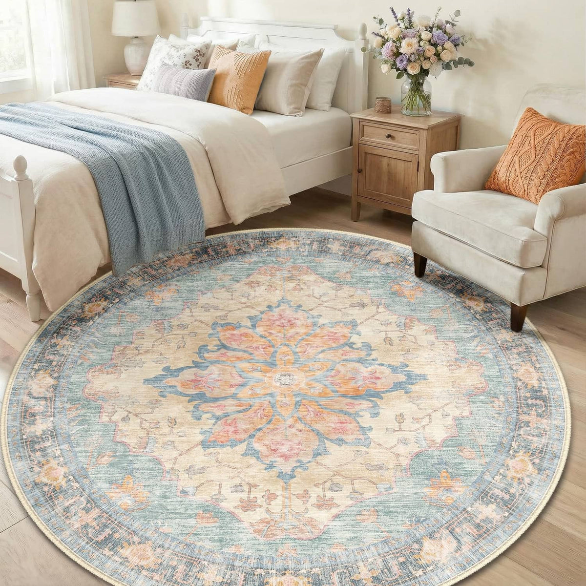 Round washable area rug with blue base and floral medallion design in orange and red