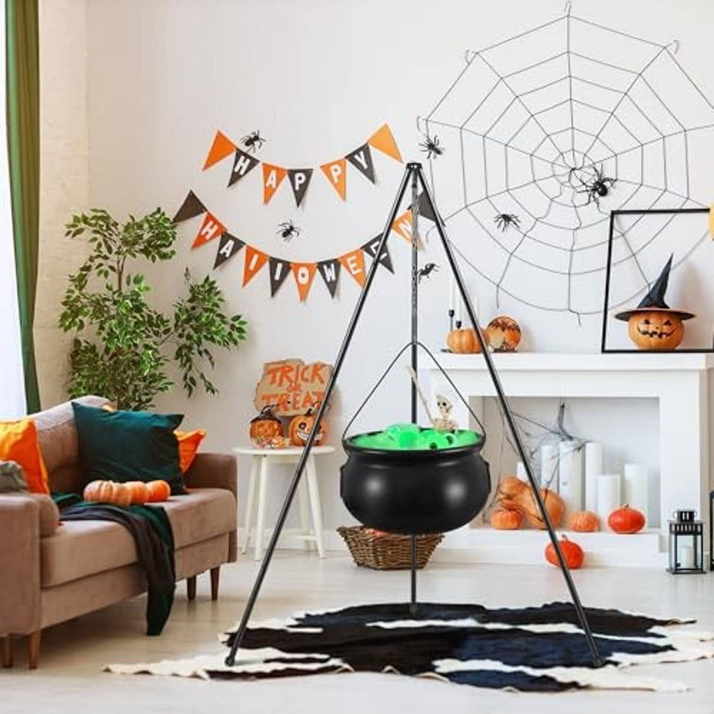 Green-lit witch cauldron hanging on tall tripod stand on a black spider-web rug