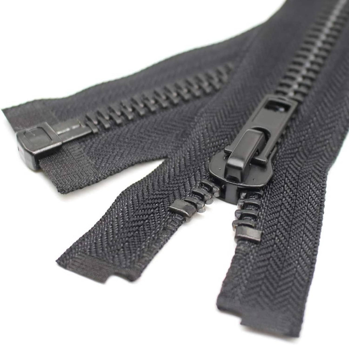 Separating zipper with dark woven tape, black metal teeth, and two-sided pull hardware.