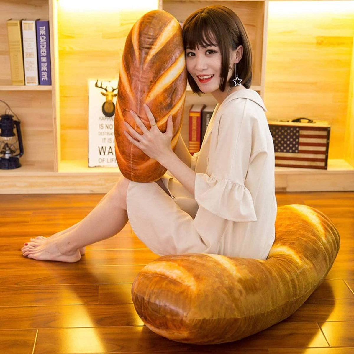 Loaf-shaped plush bread pillow with cream slice lines, rounded end view