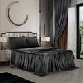 Black satin bedding sheet set on queen bed, draped flat sheet and pillowcases