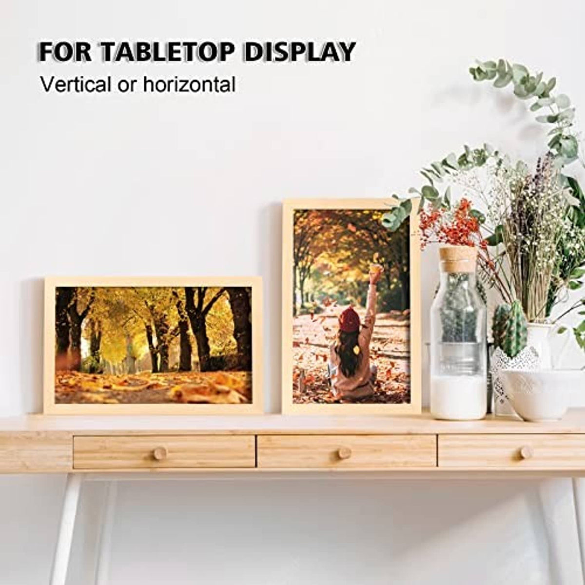 Natural wood picture frames with clear acrylic fronts displayed on a tabletop shelf
