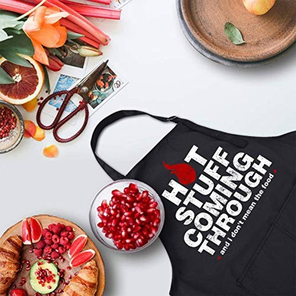 Black apron with bold “HOT STUFF COMING THROUGH” slogan and neck strap