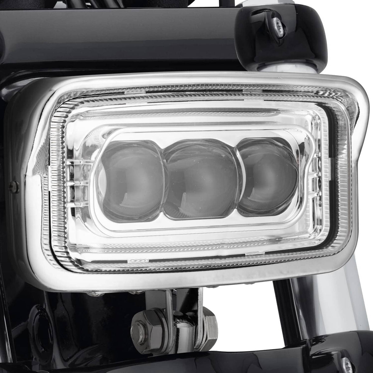 Close-up of squared LED headlight lens with three reflective light chambers