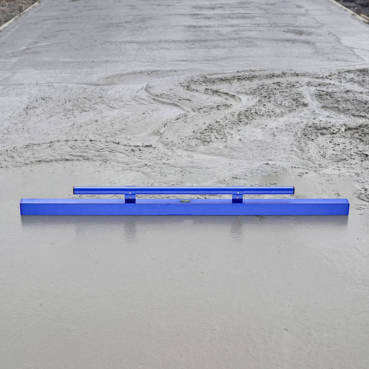 Blue aluminum screed board placed on gray concrete for smoothing a flat surface