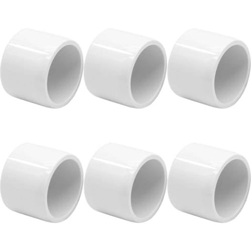 Multiple white PVC pipe end caps, 1-1/4 in, open-cup ends, smooth finish