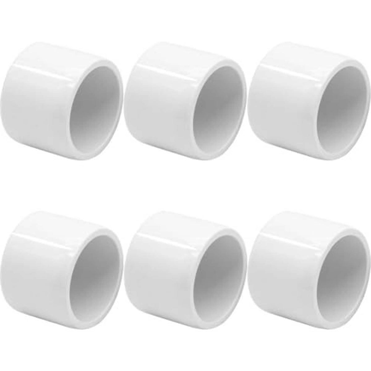Multiple white PVC pipe end caps, 1-1/4 in, open-cup ends, smooth finish