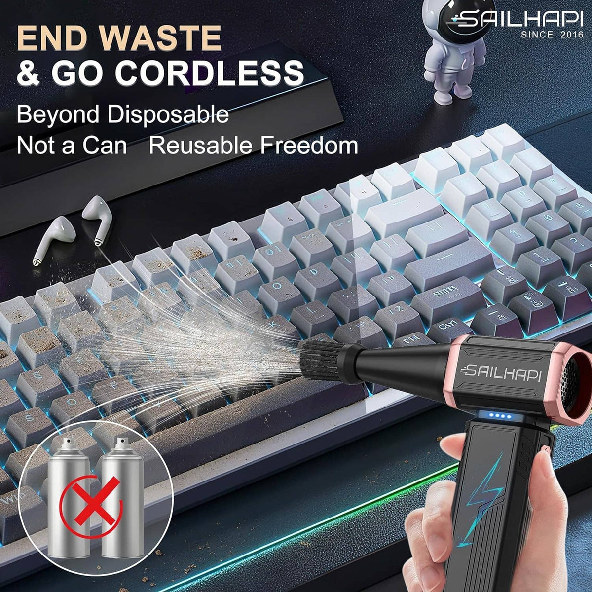 Handheld cordless air duster blowing across keyboard keys to remove dust