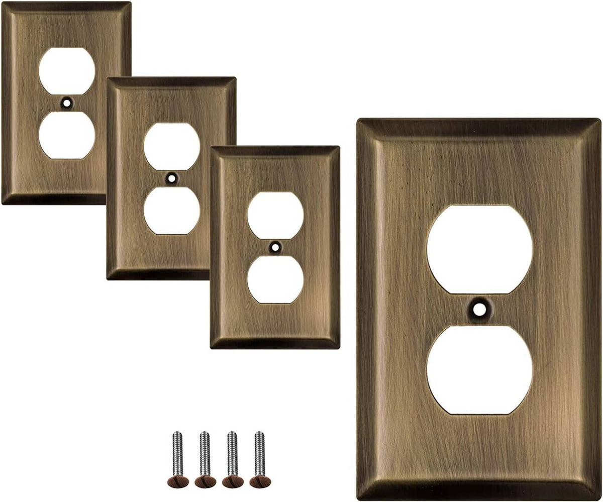 Antique brass duplex wall plates with two outlet openings; shown with mounting screws.