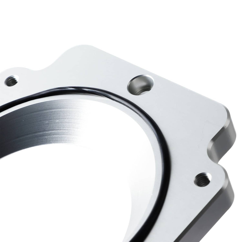 Close-up throttle body adapter sealing ring with black rubber gasket on metal flange