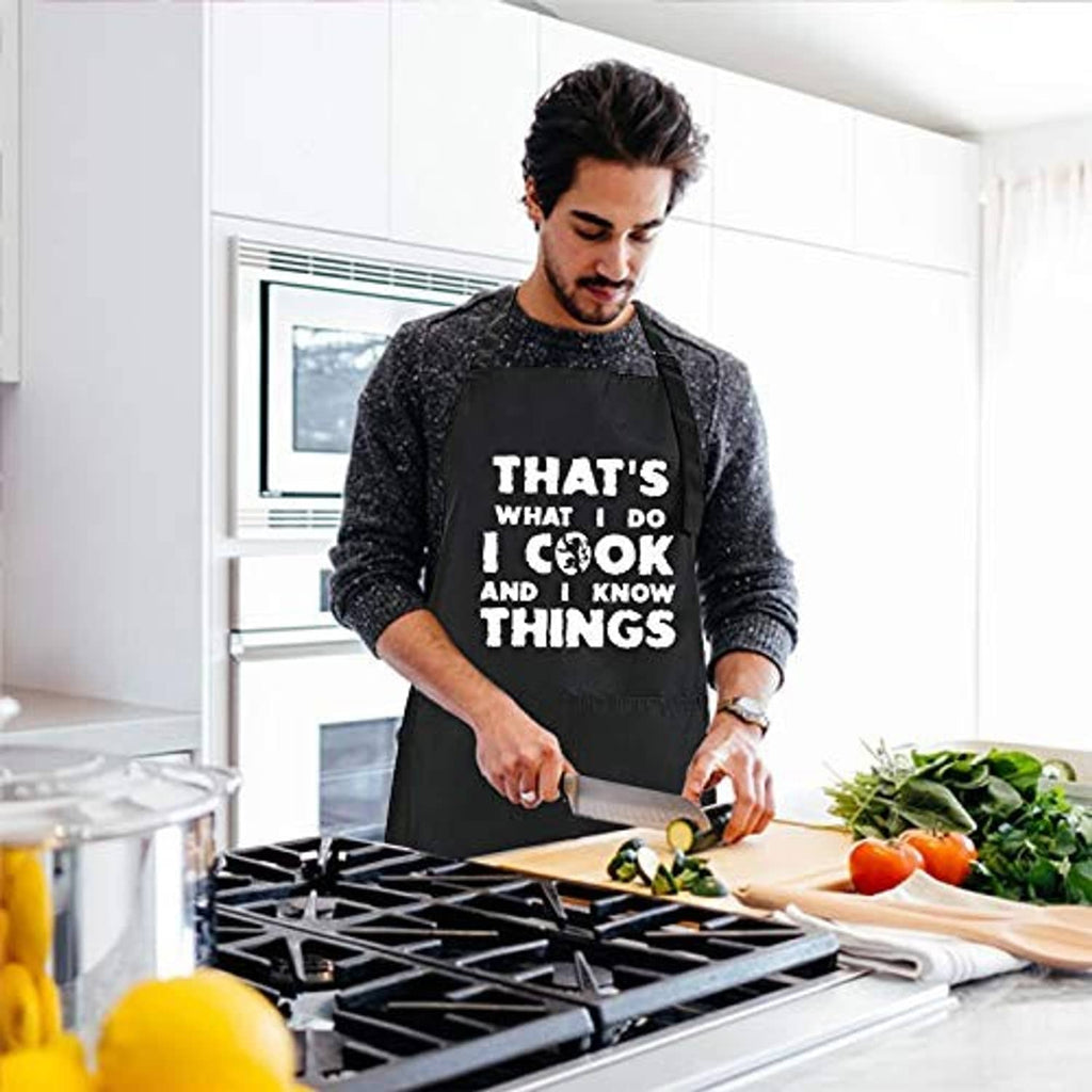 Black chef apron worn by a cook with bold white 'That's what I do...' slogan