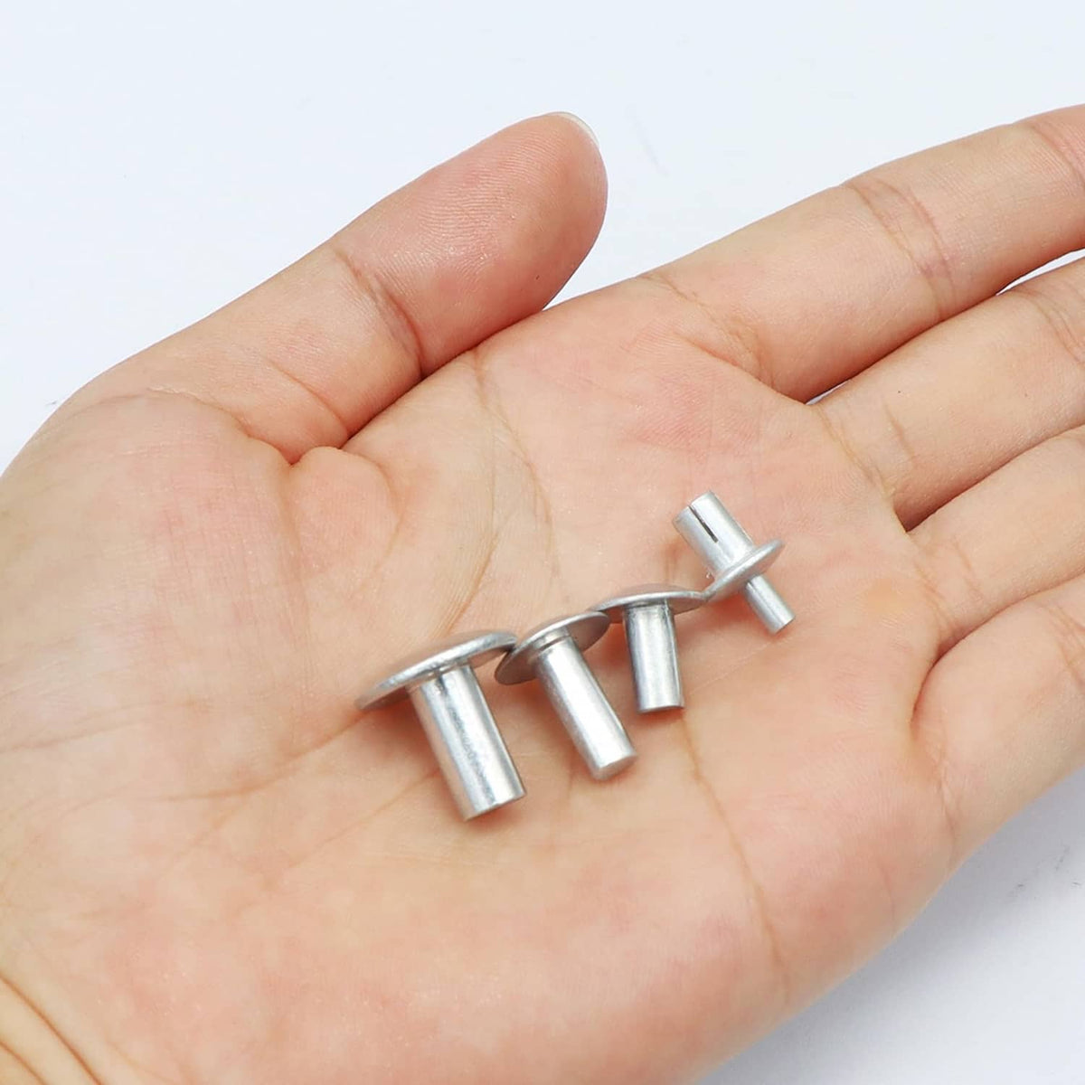 Brazier head aluminum rivets held in hand, silvery