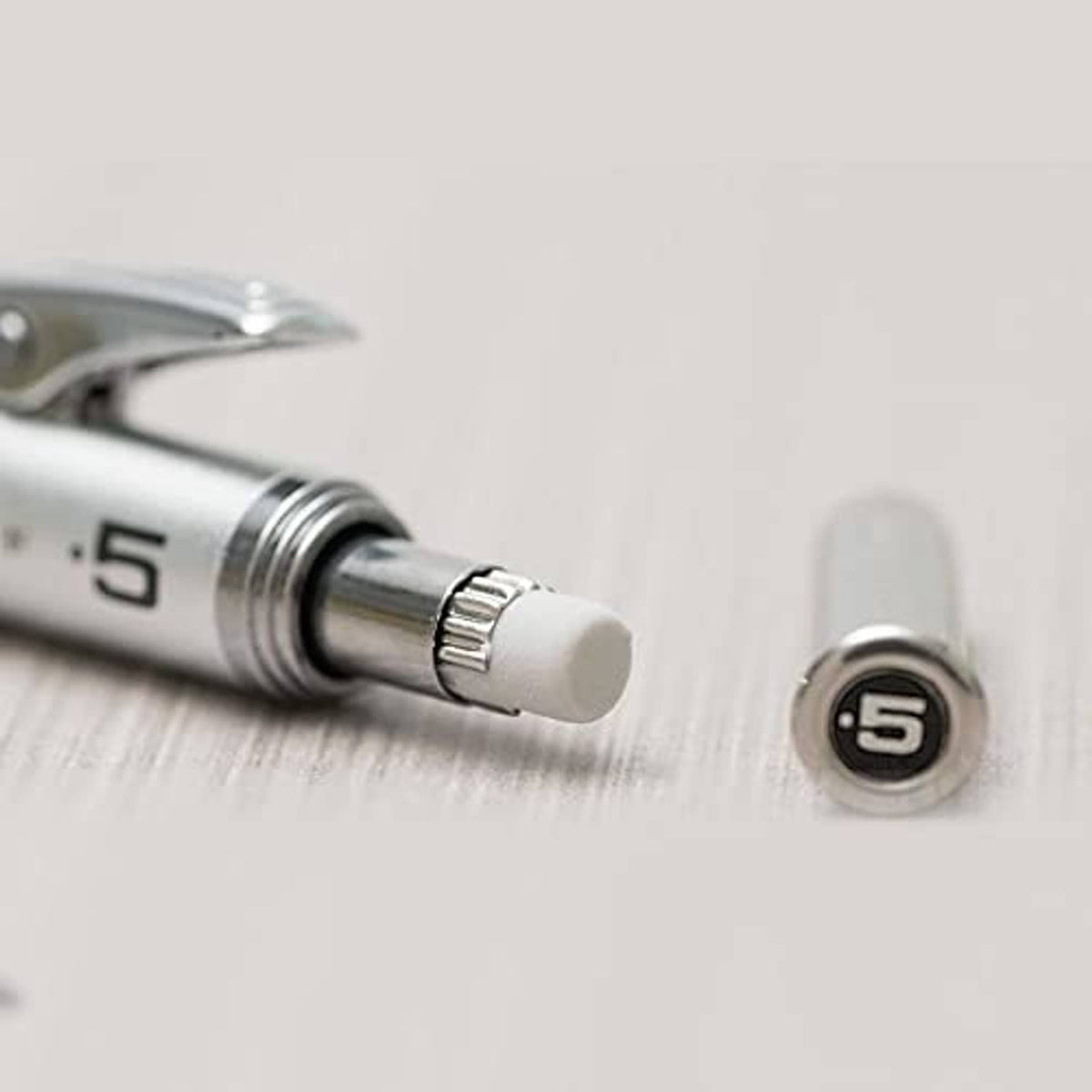 Close-up of retractable lead sleeve and textured adjustment ring near pencil tip