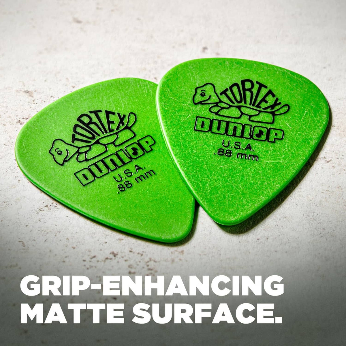 Two green Dunlop Tortex guitar picks, U.S.A., .88 mm, with logo text.