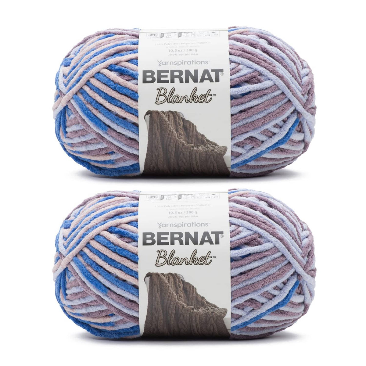 Two Bernat super bulky yarn skeins in dappled blue, lilac, and gray color mix