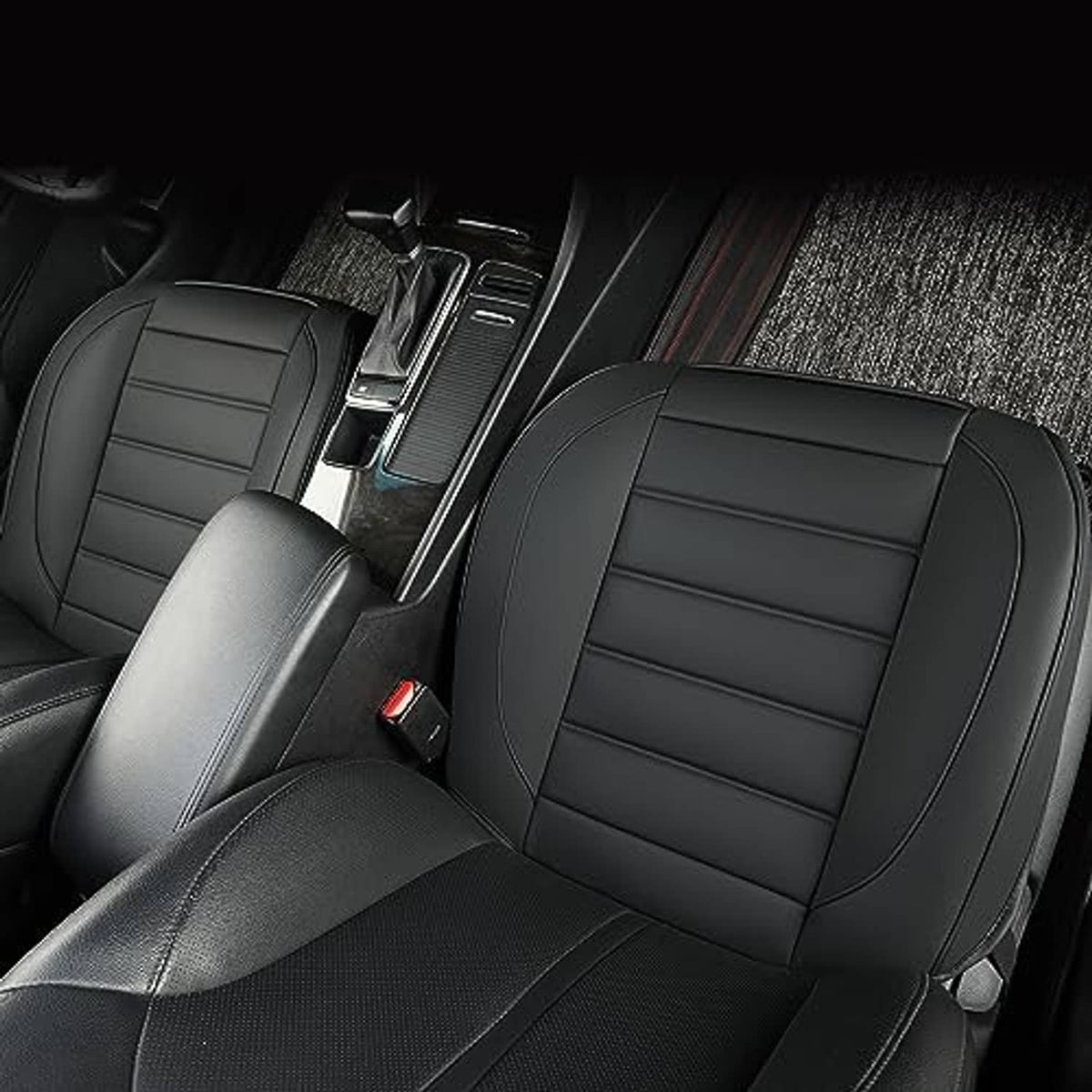 Black front seat bottom cover installed on seat cushion with stitched panel seams