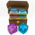 Stress cubes: one purple and one blue Big Block in an open box