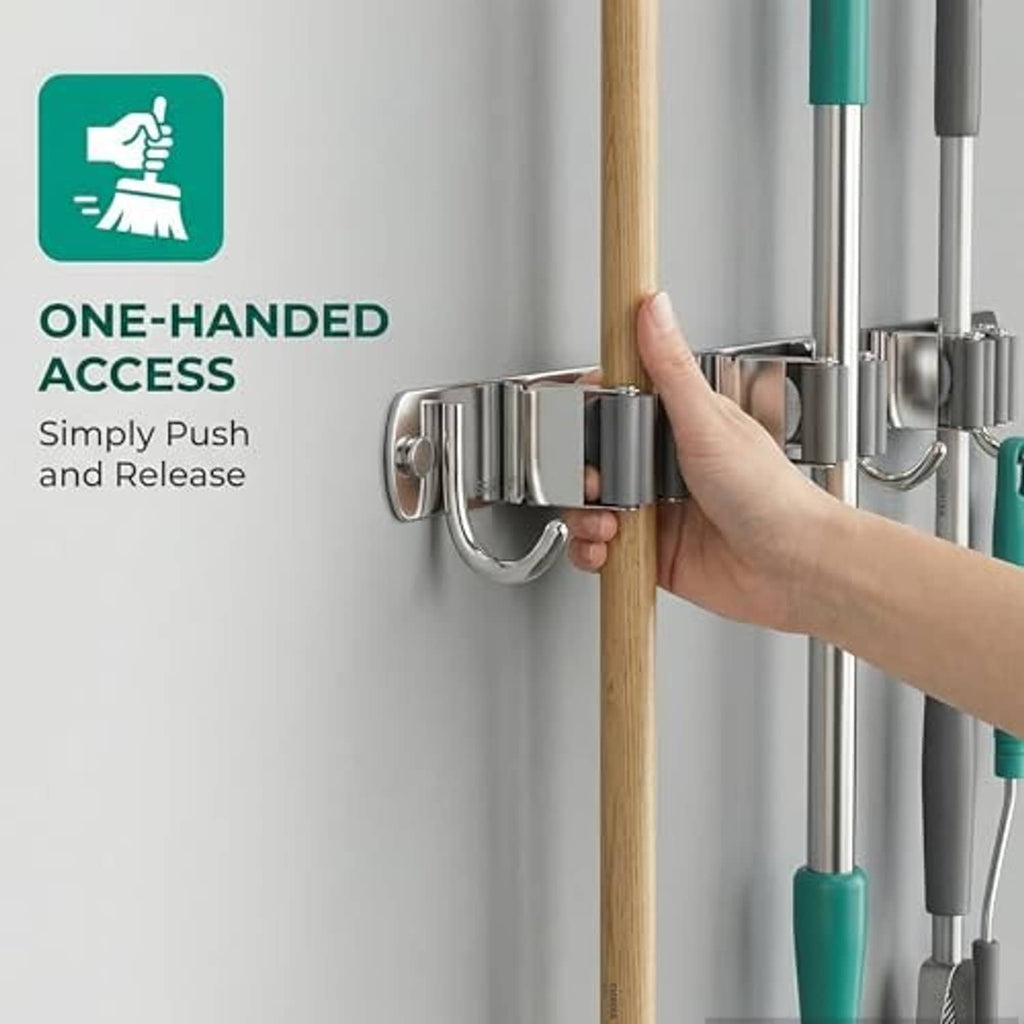 Chrome broom organizer with four hooks and three grip bars, hand pushing a wooden handle
