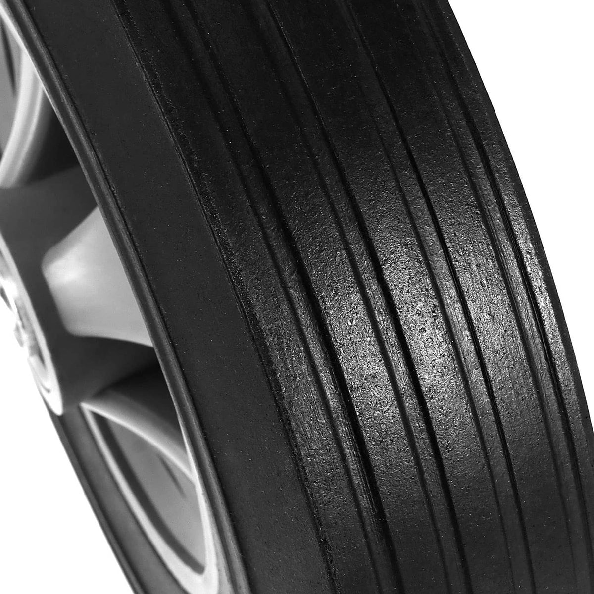 Black rubber wheel tread with deep grooves for traction