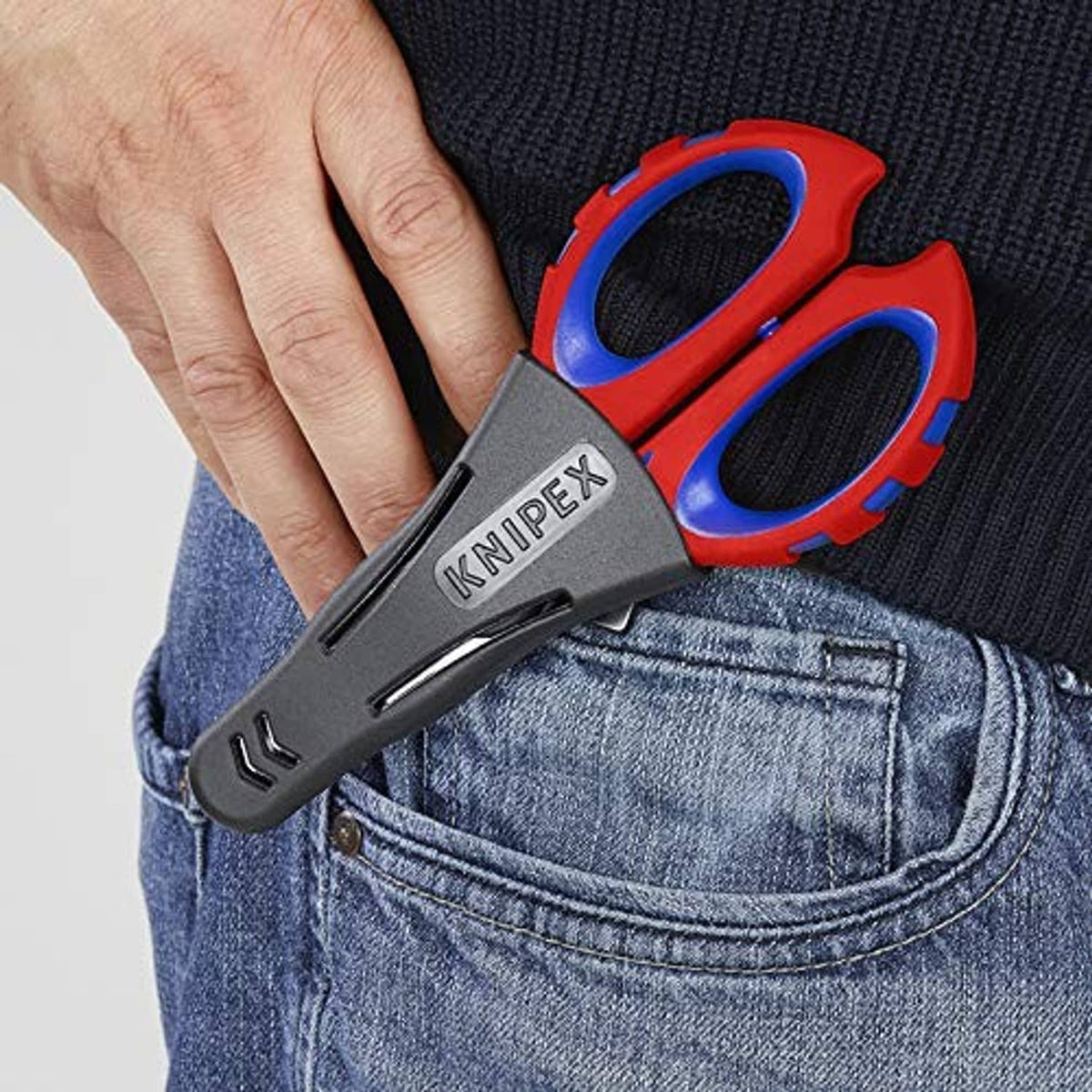 Electricians' shears held in hand, black KNIPEX logo and red-and-blue handle design