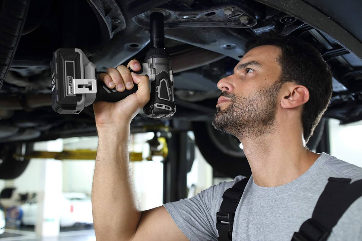 Axle nut socket being tightened under a vehicle using a power drill