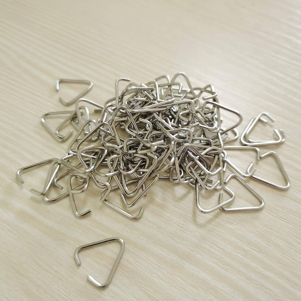 Pile of triangle open jump rings, silver-tone metal pinch-bail clip connectors