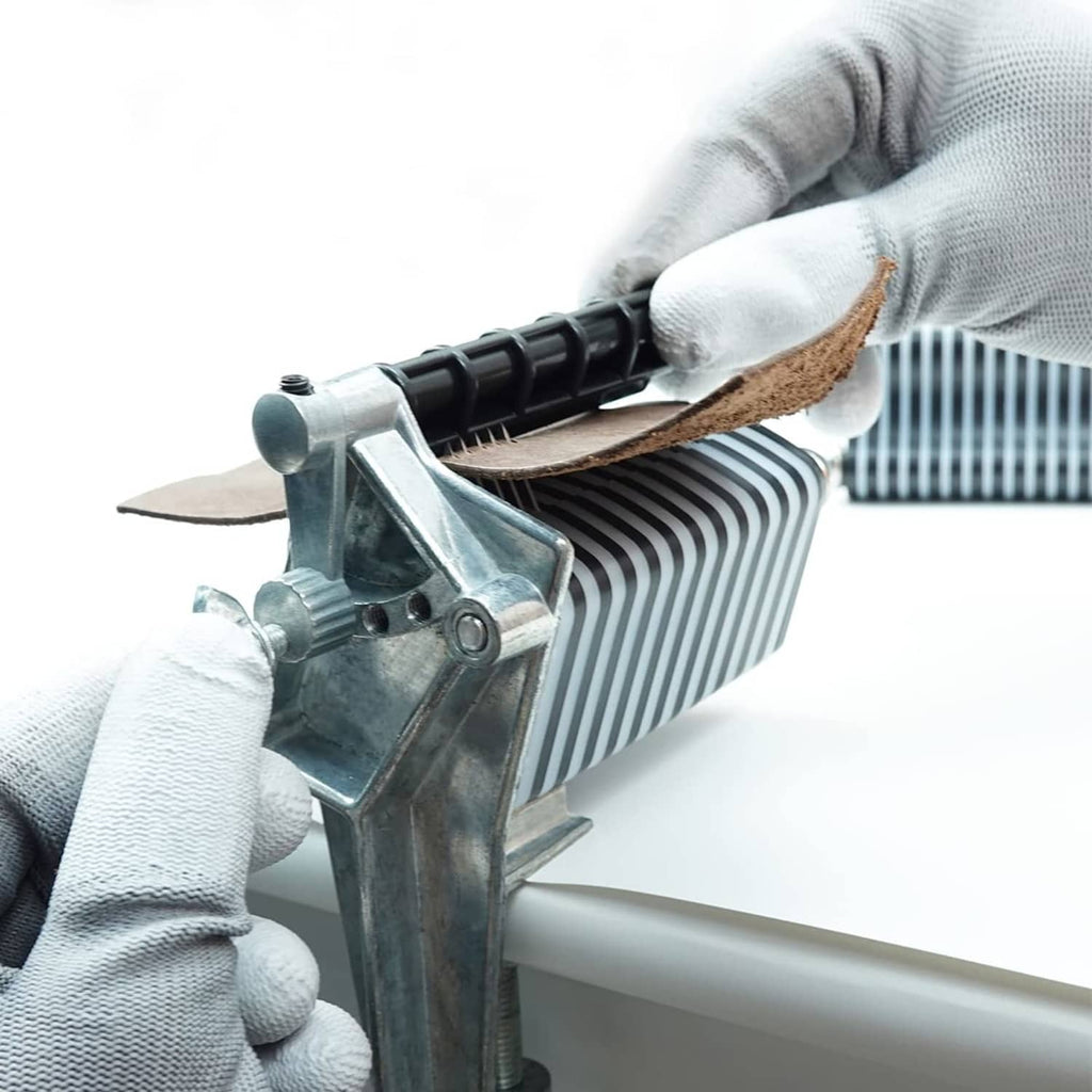 Leather lace cutter cutting action with gloved hands and striped feed drum