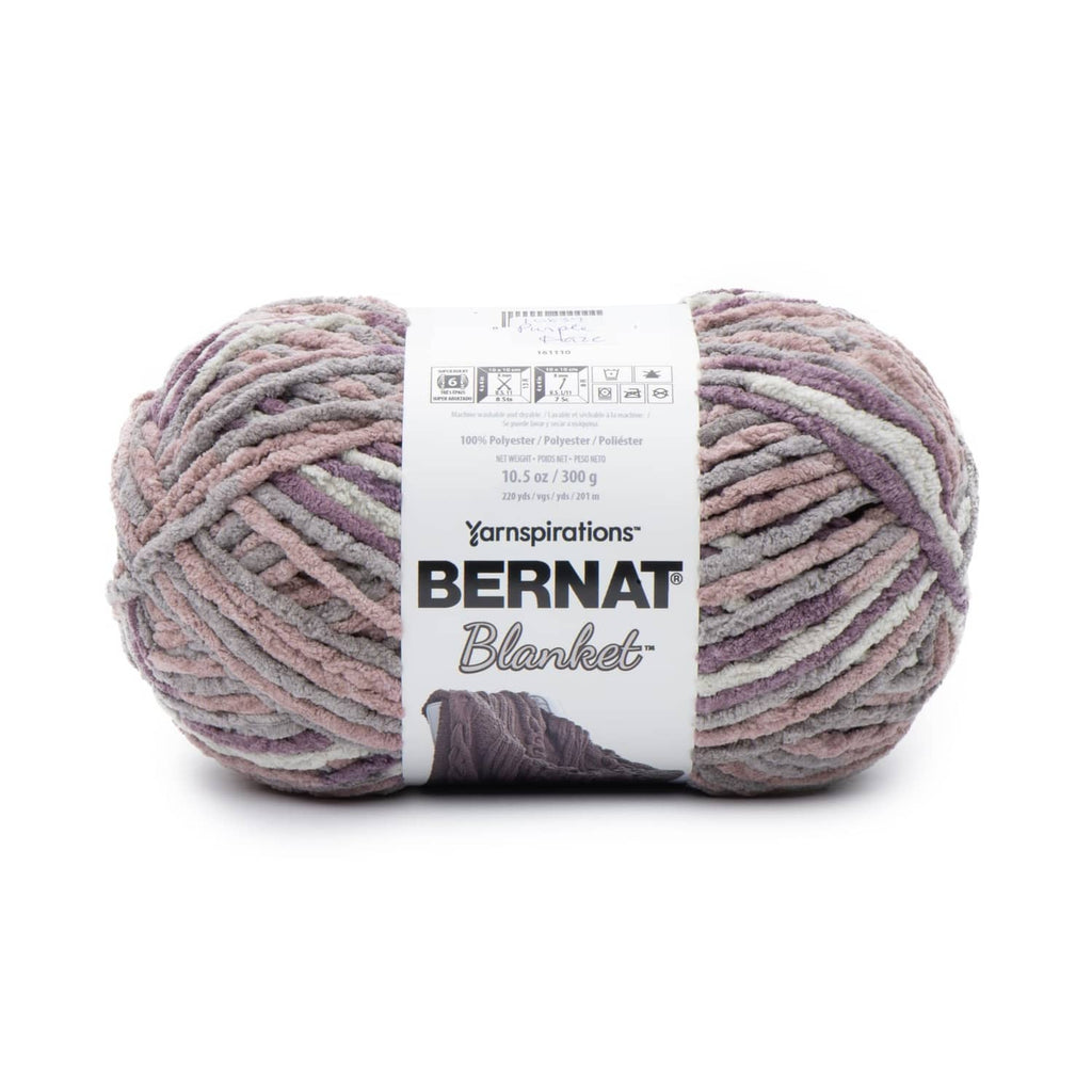 Bernat Super Bulky chenille-style yarn skein in mauve, purple, and gray tones