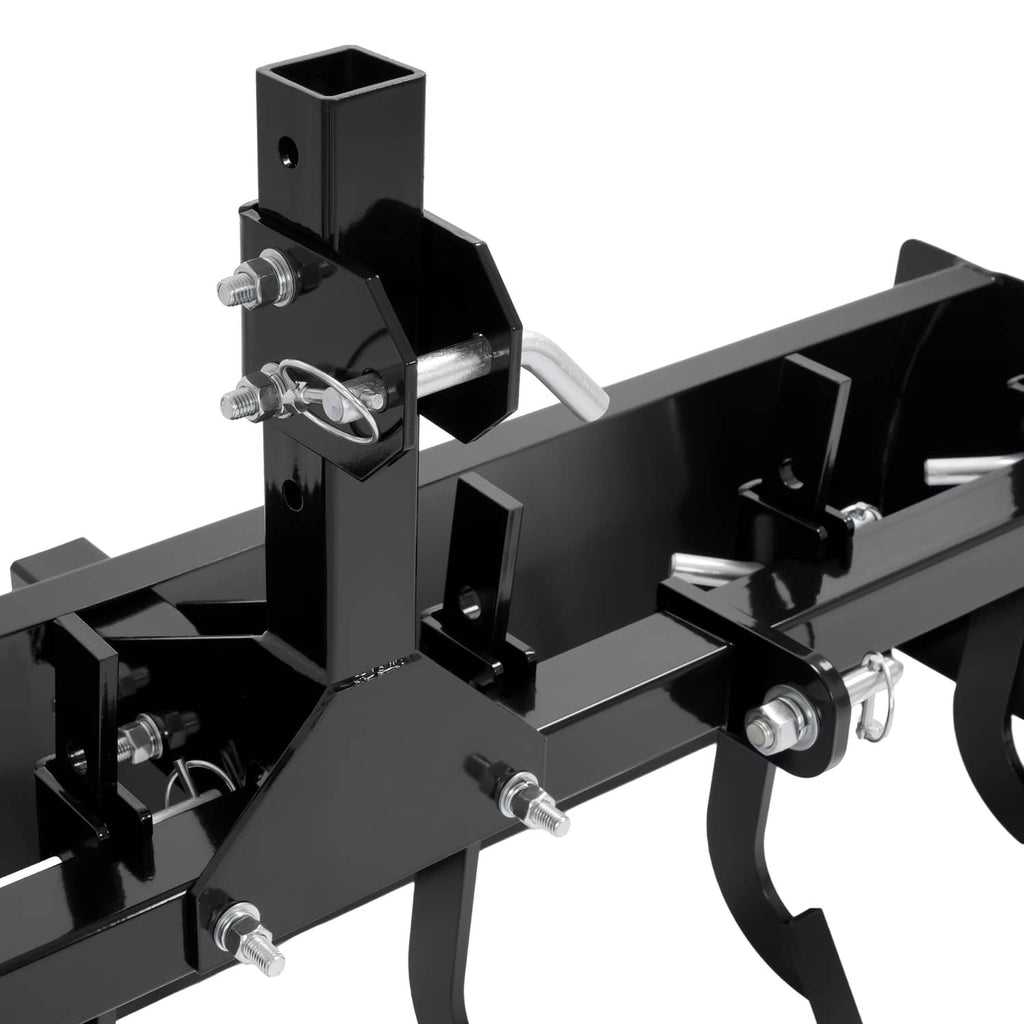Close-up of three-point hitch mount and black scraper blade with mounting pins and hardware