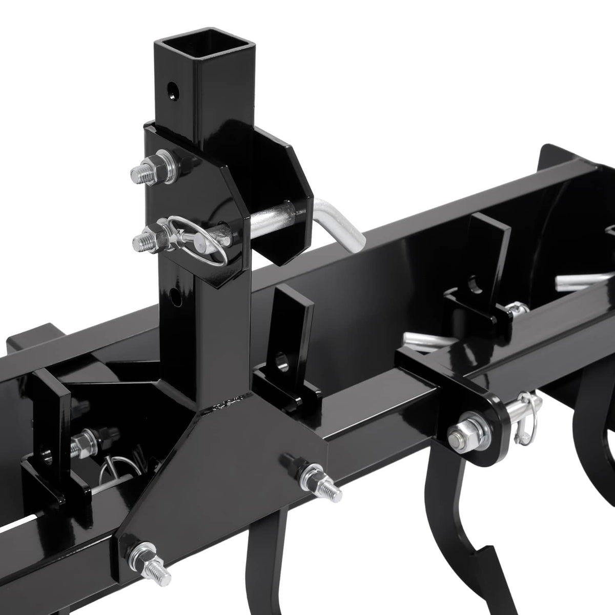 Close-up of three-point hitch mount and black scraper blade with mounting pins and hardware