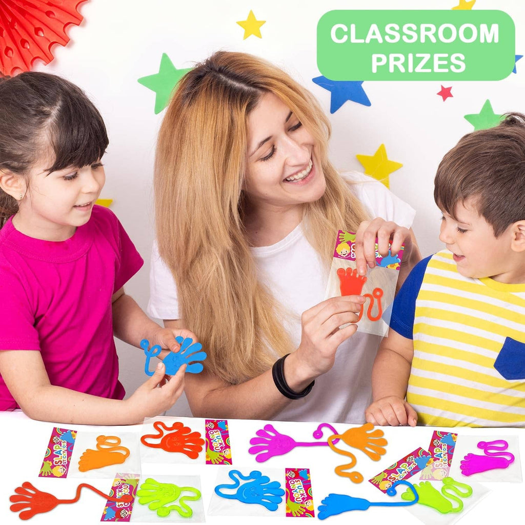 Kids playing with colorful sticky hand and foot party favors in class