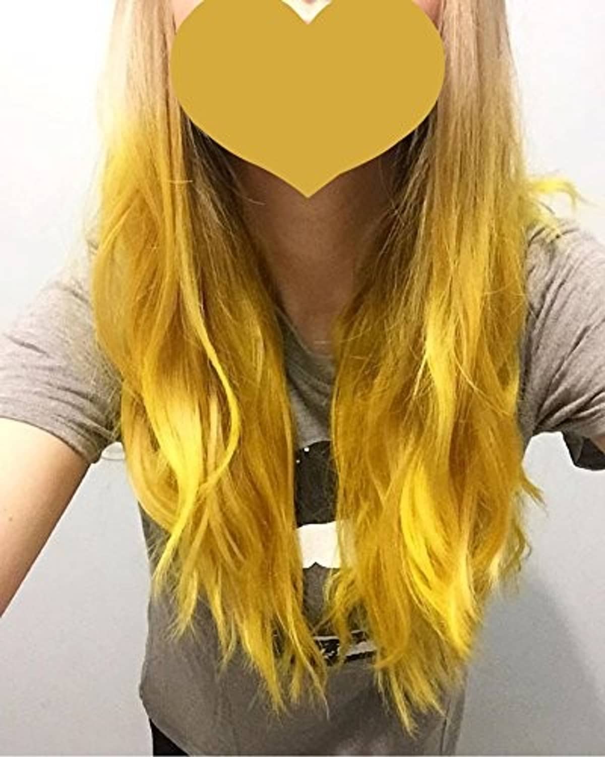 Long golden-yellow hair on model, flowing strands framing shoulders