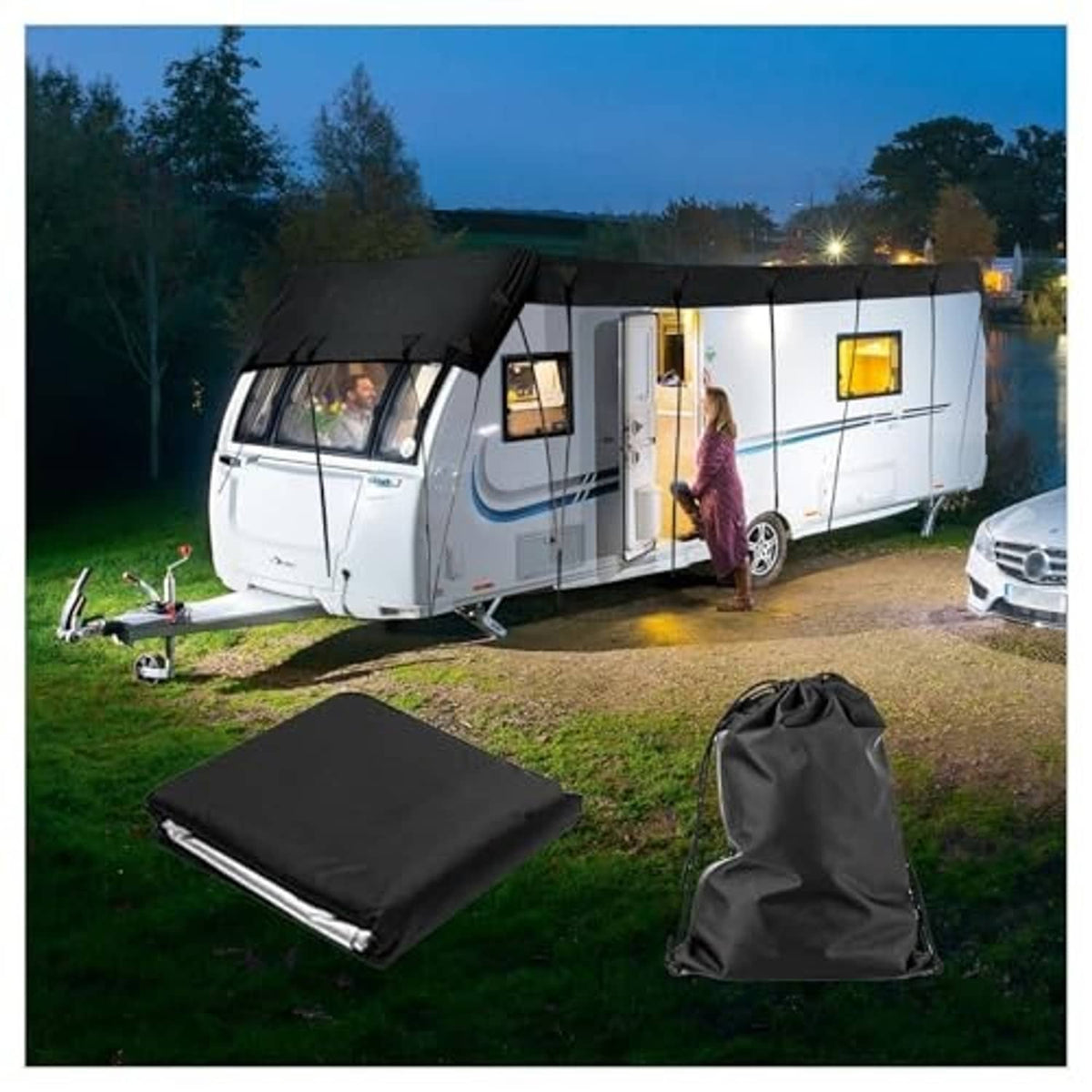 Black RV cover tarp laid over a travel trailer with matching storage bag