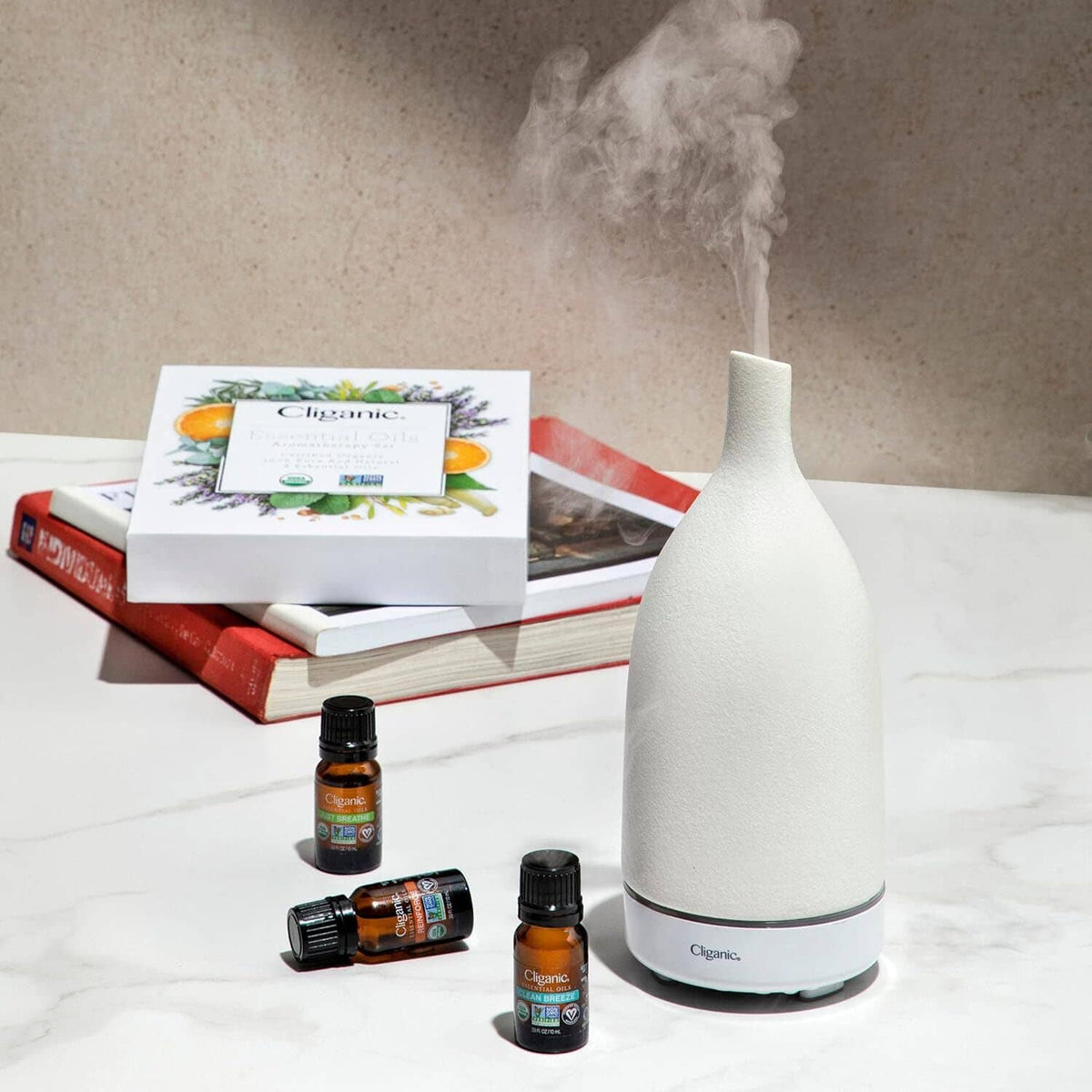 Lavender essential oil set with small amber bottles and white aroma diffuser.