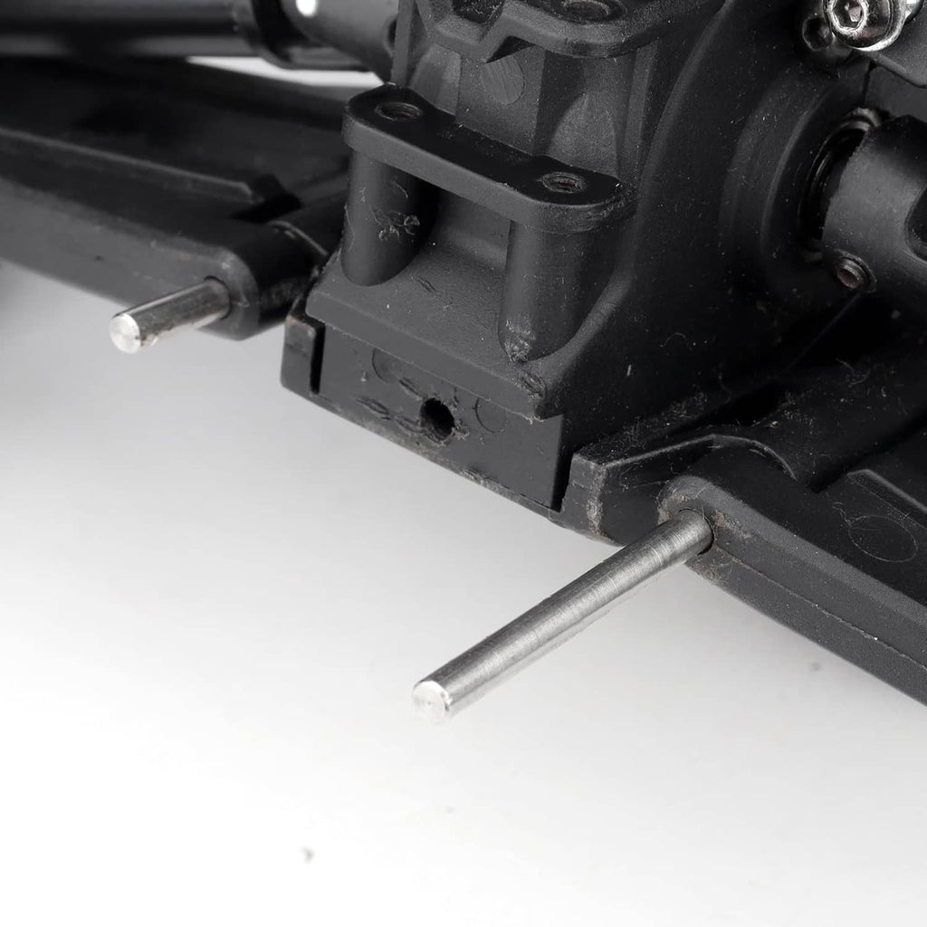 Close-up: silver suspension pin screw installed in black RC suspension arm