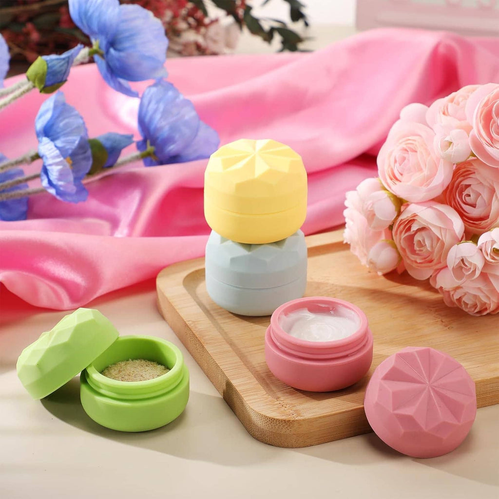 Small silicone cream jars with faceted lids in green, pink, and yellow, with lids closed