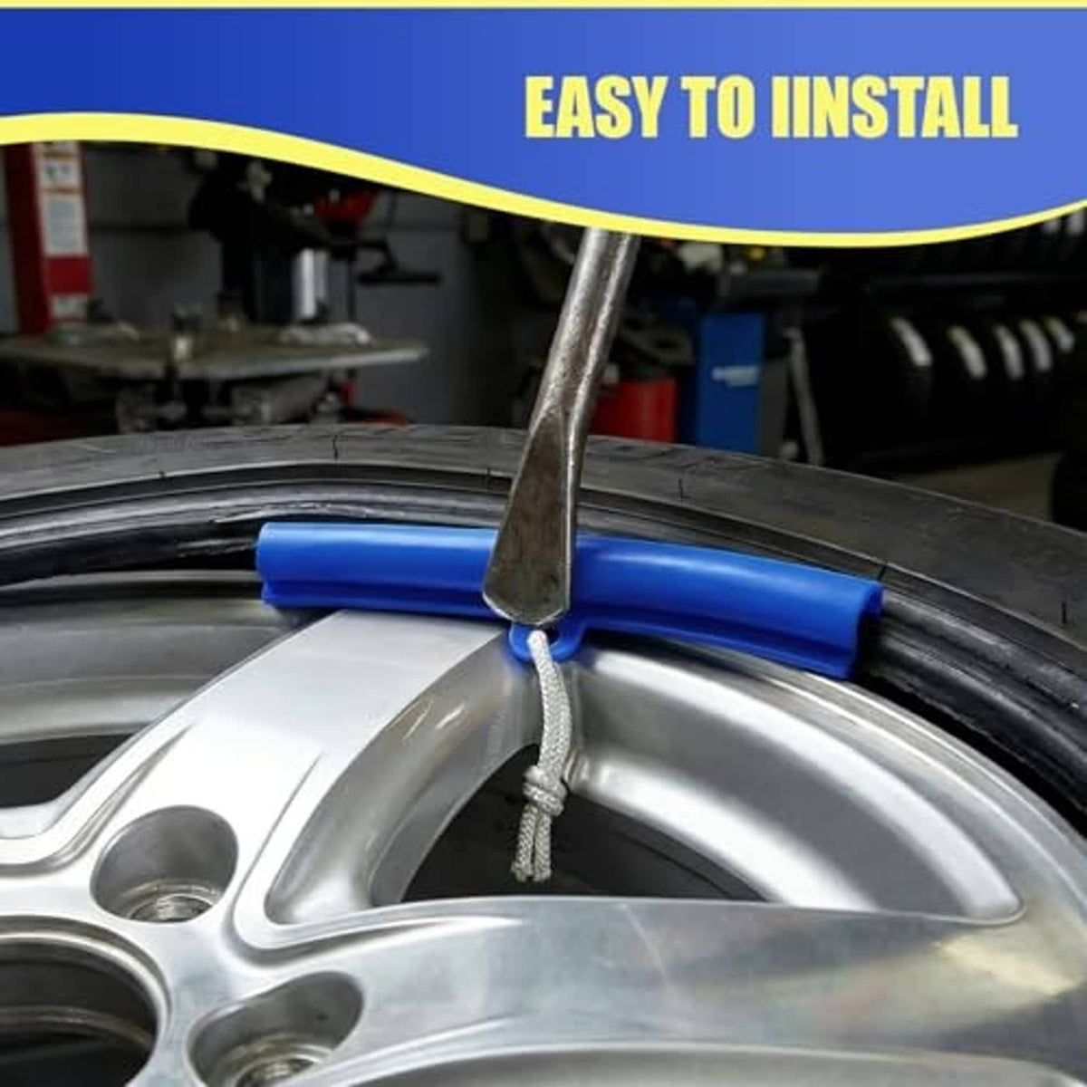 Blue rim protector guard on wheel rim with gray cord and metal bar