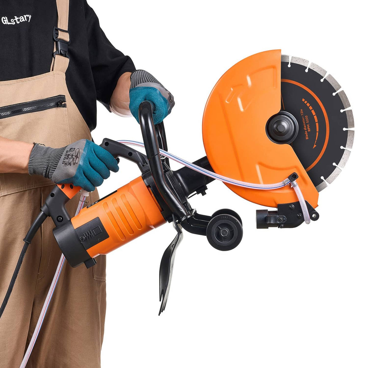 Electric concrete saw in use with gloved hands, orange/black tool and circular blade