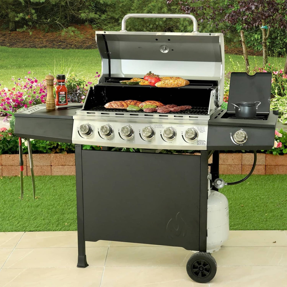 Grill with connected 2-ft black propane regulator and hose leading to a propane tank