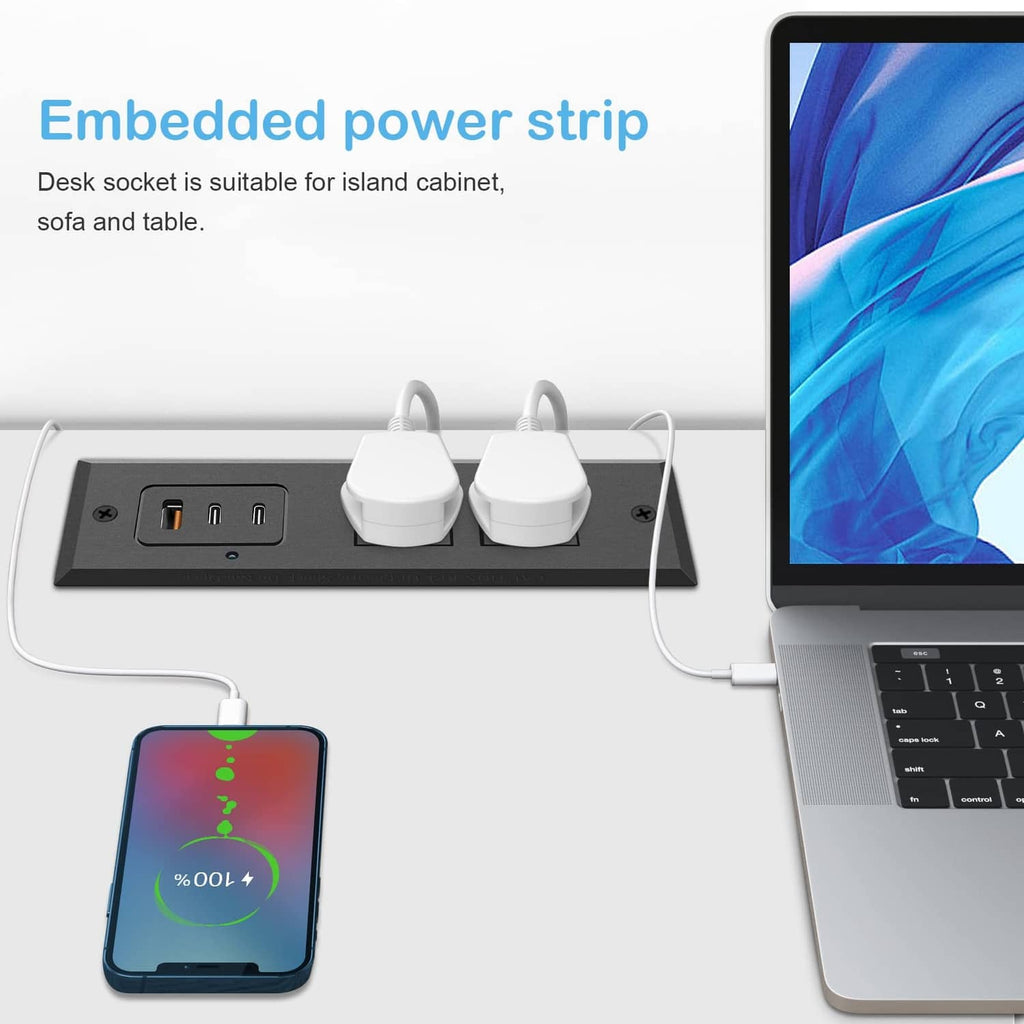 Recessed power strip on a desk surface with USB ports, AC sockets, and charging devices