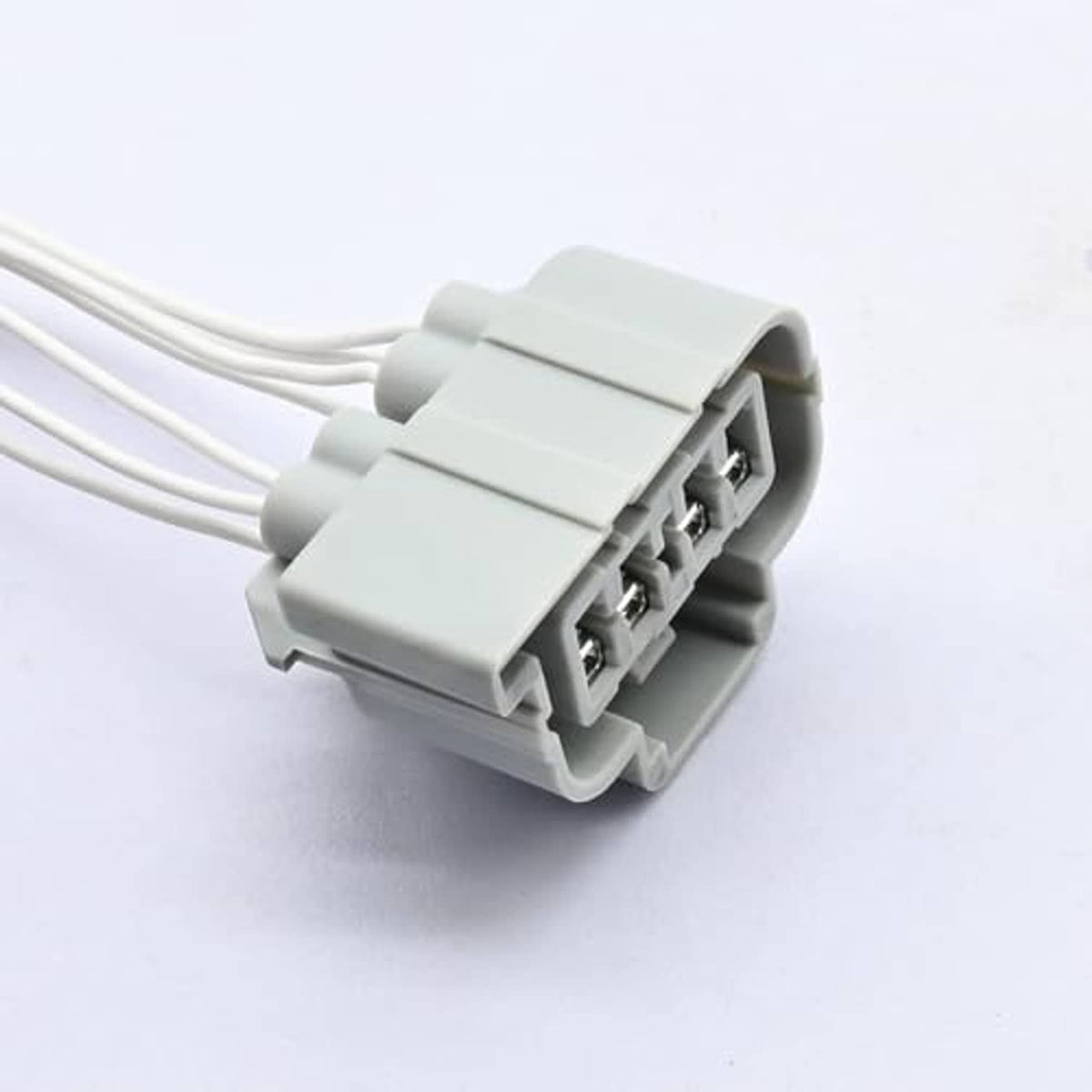 Headlight connector pigtail harness close-up of gray plug with three wire leads