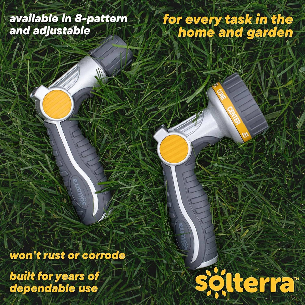 Two adjustable garden hose nozzles with yellow dials and gray non-slip grips on grass