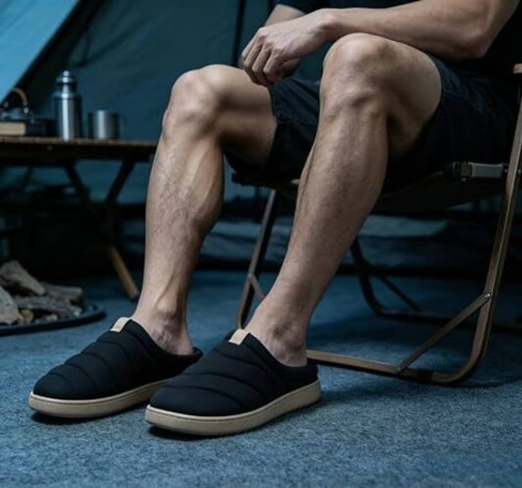 Men's black slip-on camp slippers with beige trim and cushioned slide sole.
