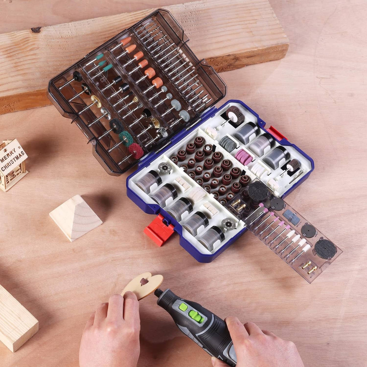 Open rotary tool accessory kit case with sanding drums, collets, and assorted bits