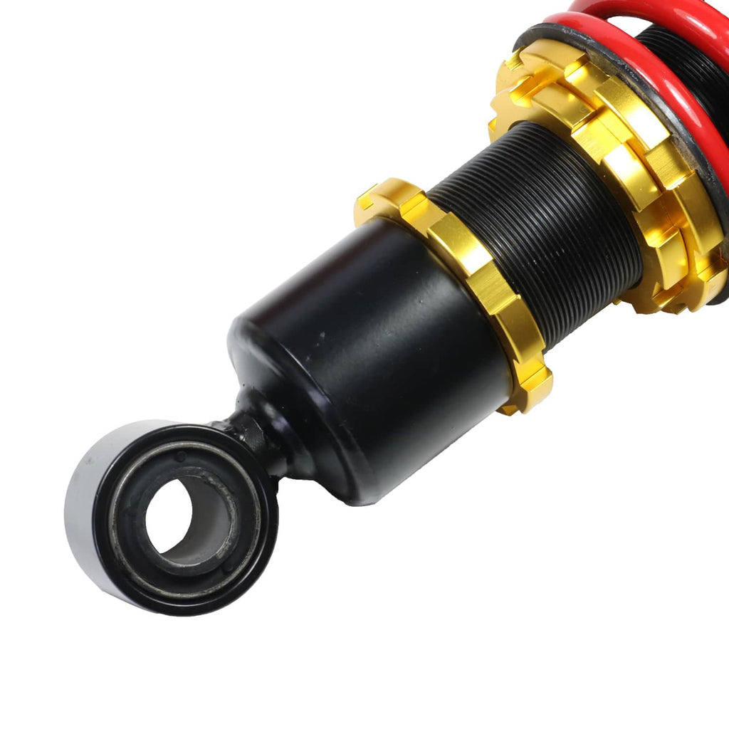 Coilover strut shock absorber with red spring, black body, gold threaded adjustment collar