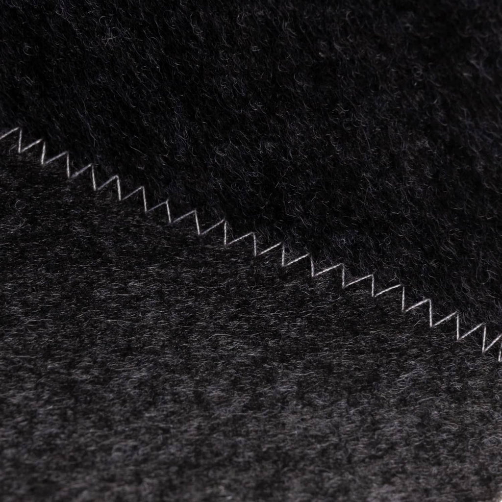 Dark grey wool sauna hat, fabric texture with white zigzag trim along edge