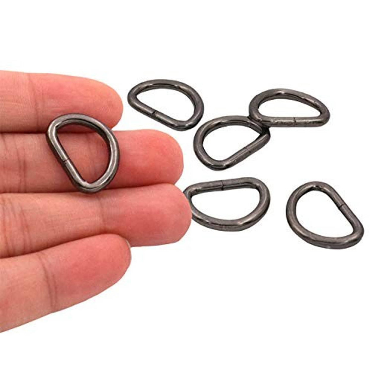 Metal D-ring buckle rings, dark bronze, shown in hand with open oval shape