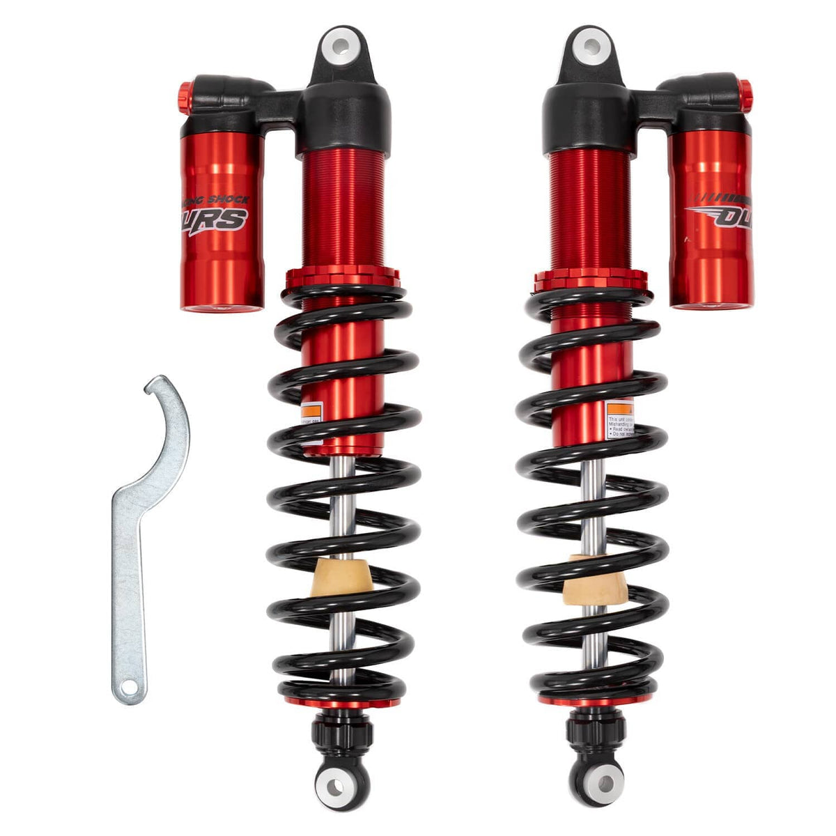 Red and black coil shock absorbers pair with mounting eyelets and wrench