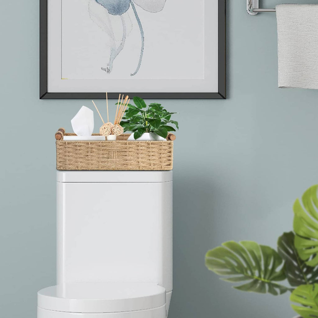 Beige woven paper rope storage basket with rope handles, open-top on white stand.