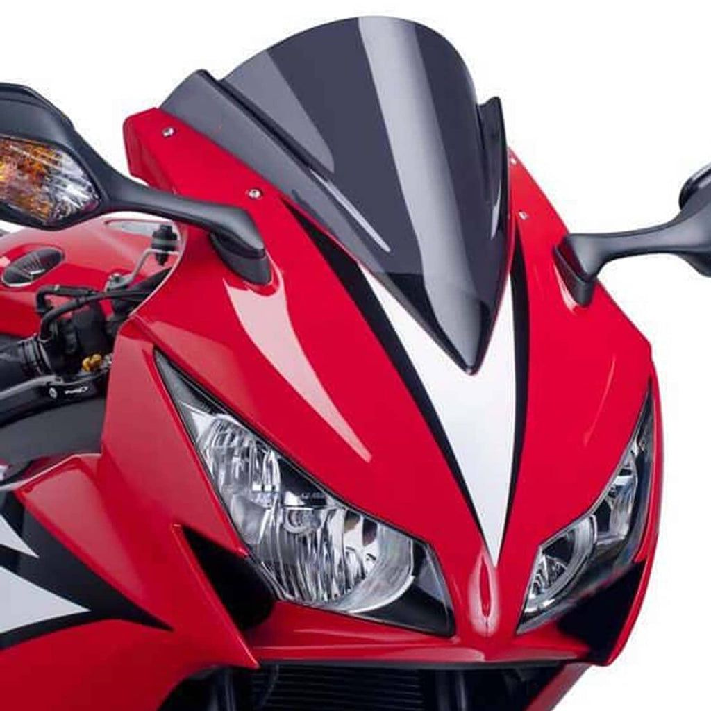 Motorcycle headlight on red sport bike with clear dual lenses and black trim